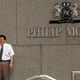 Two workers take a cigarette break outside the then-headquarters of Philip Morris on July 25, 2001 in New York City.
